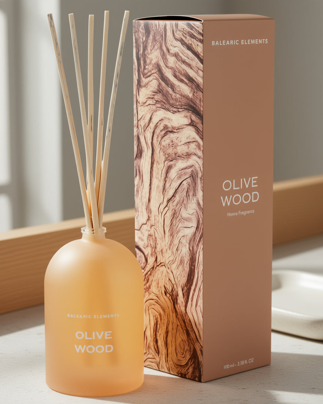 Olive Wood diffuser bottle and packaging on a neutral background