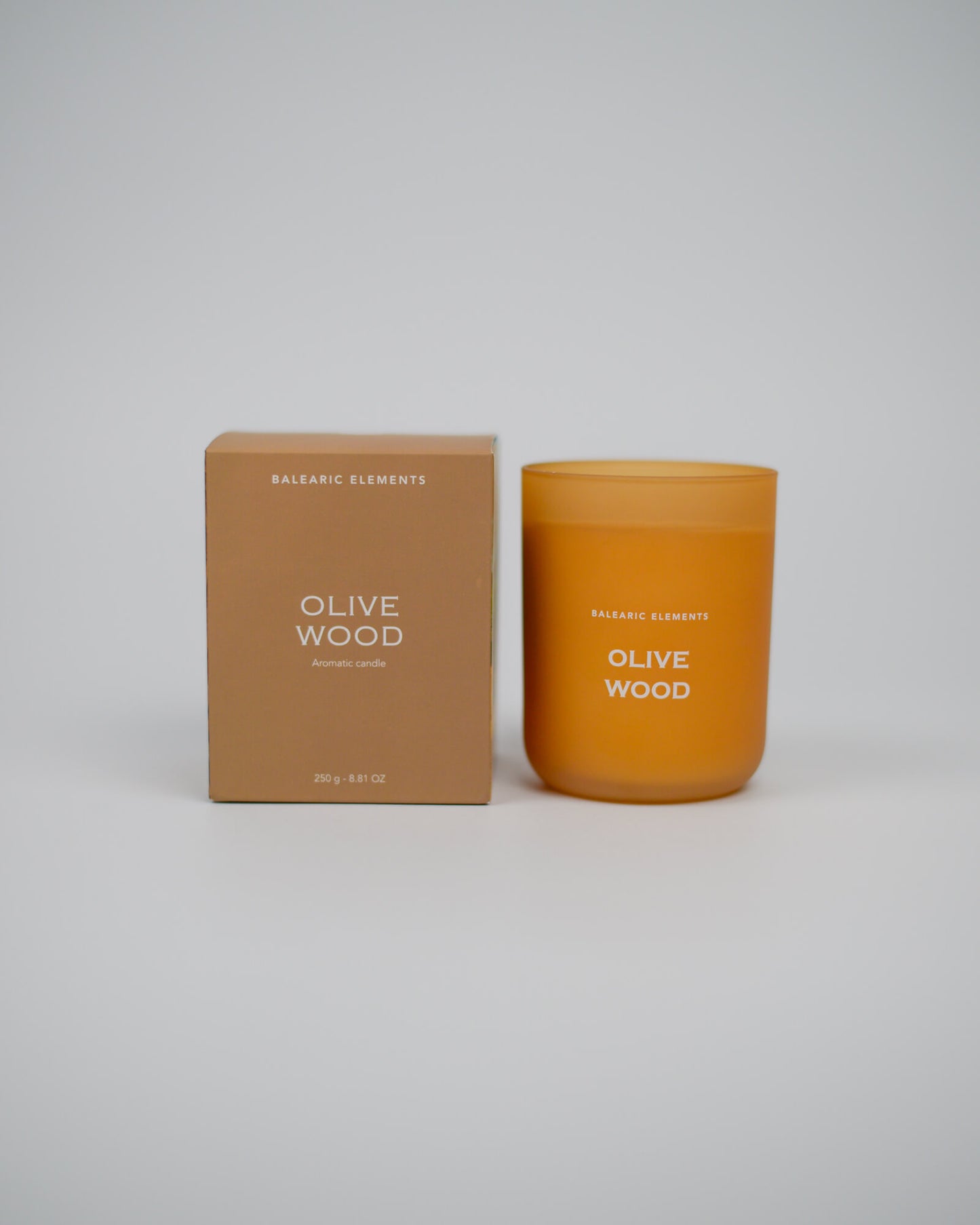 Scented candle labeled 'Olive Wood' with a matching box on a white background