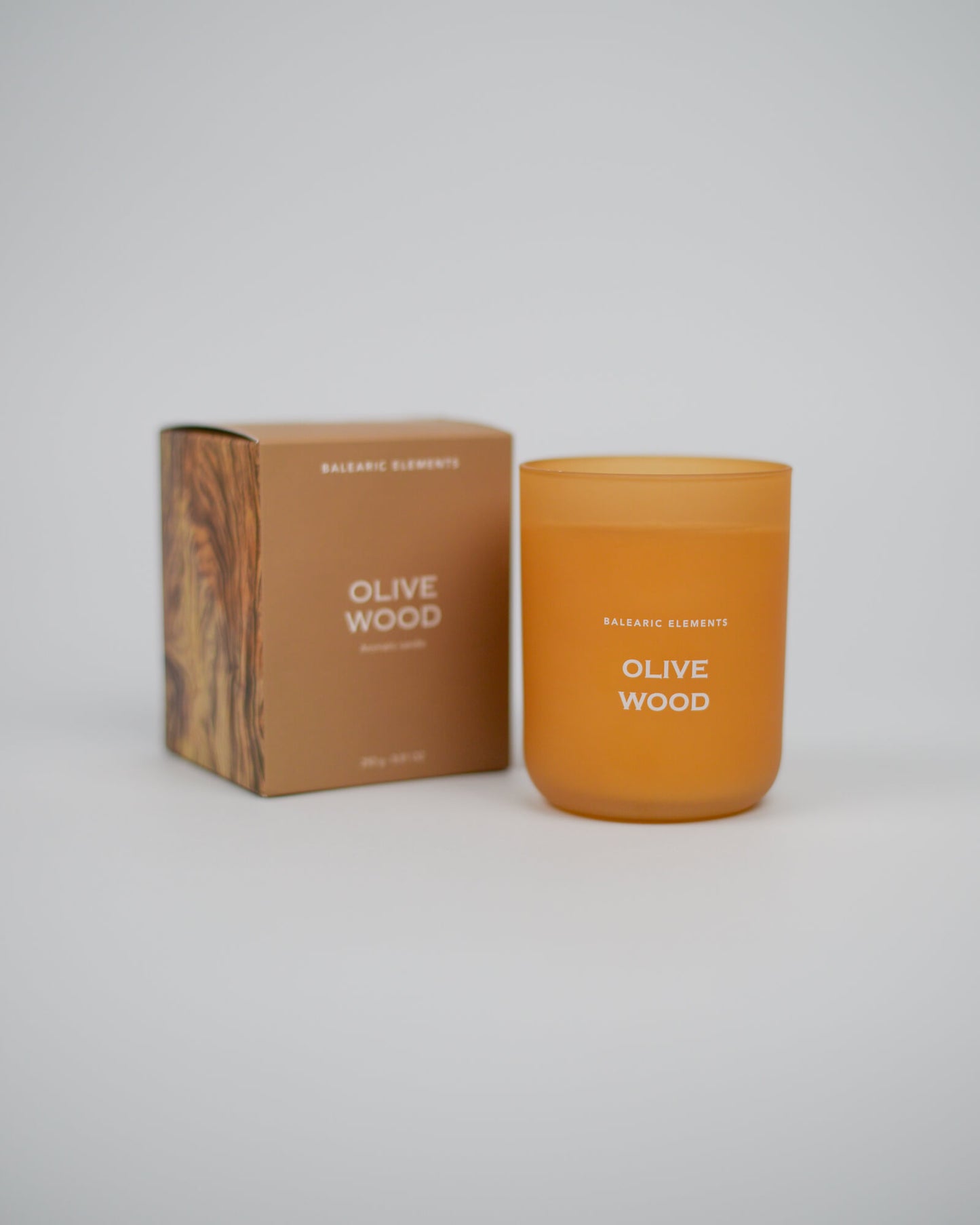 Olive Wood scented candle and packaging on a white background