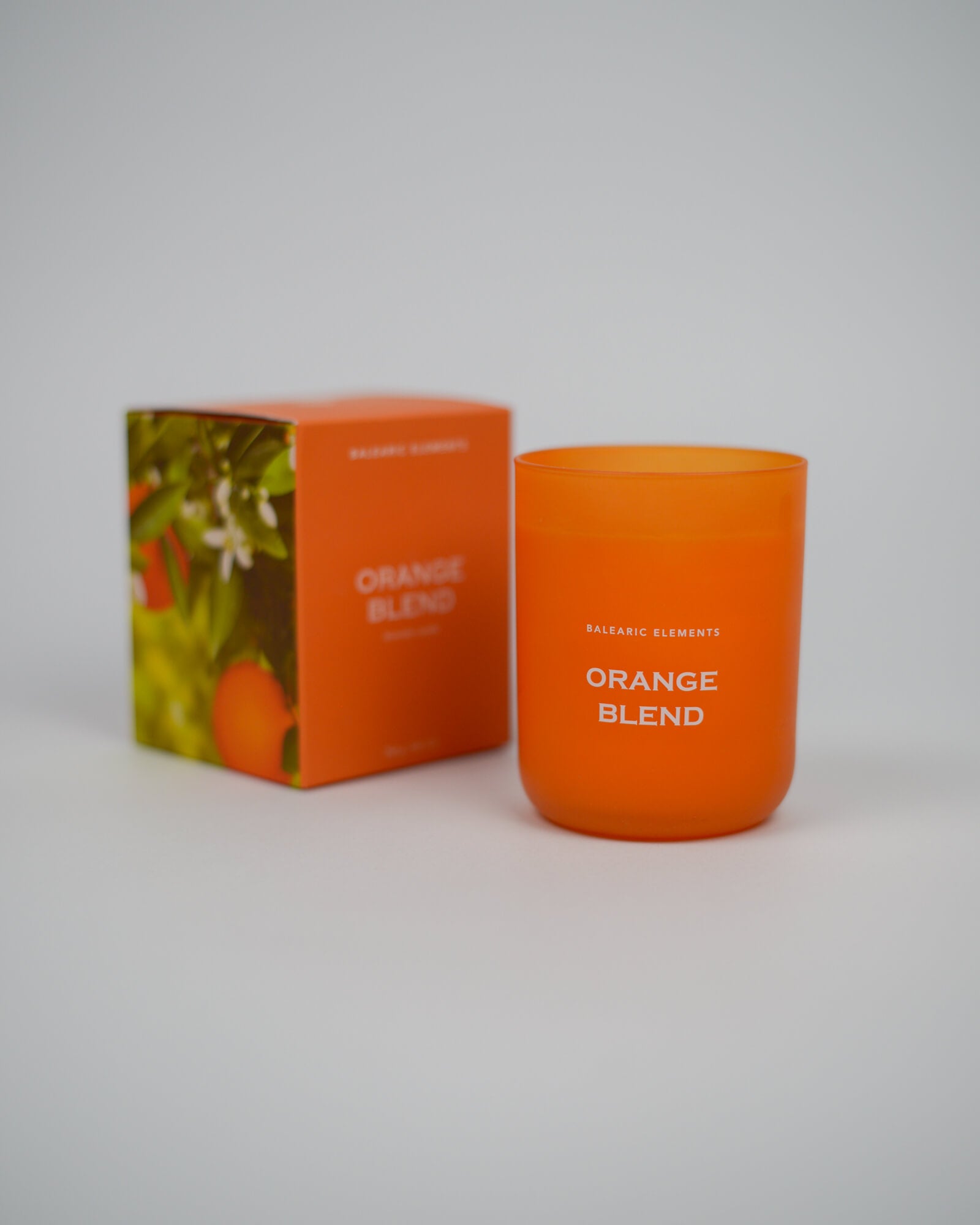 Orange scented candle labeled 'Orange Blend' with packaging on a white background