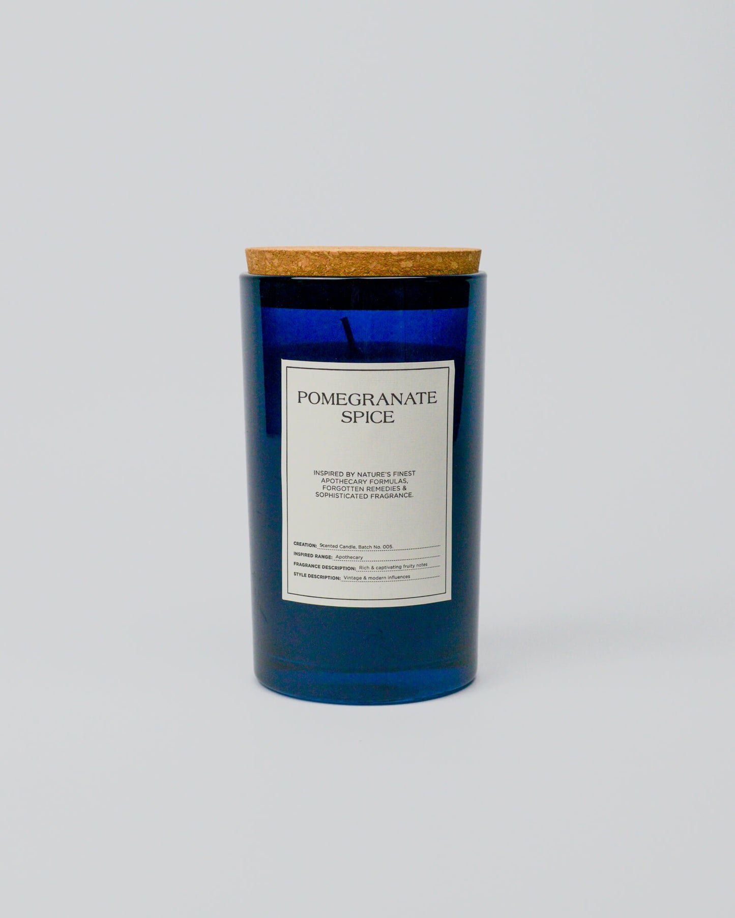 Blue glass jar candle with a label on a white background