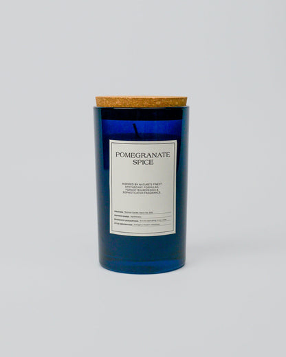 Blue glass jar candle with a label on a white background