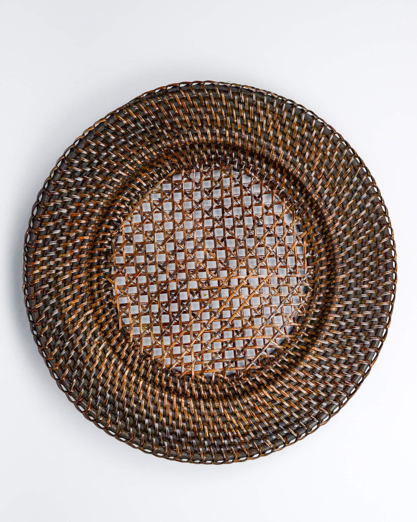 Woven rattan plate on a white background