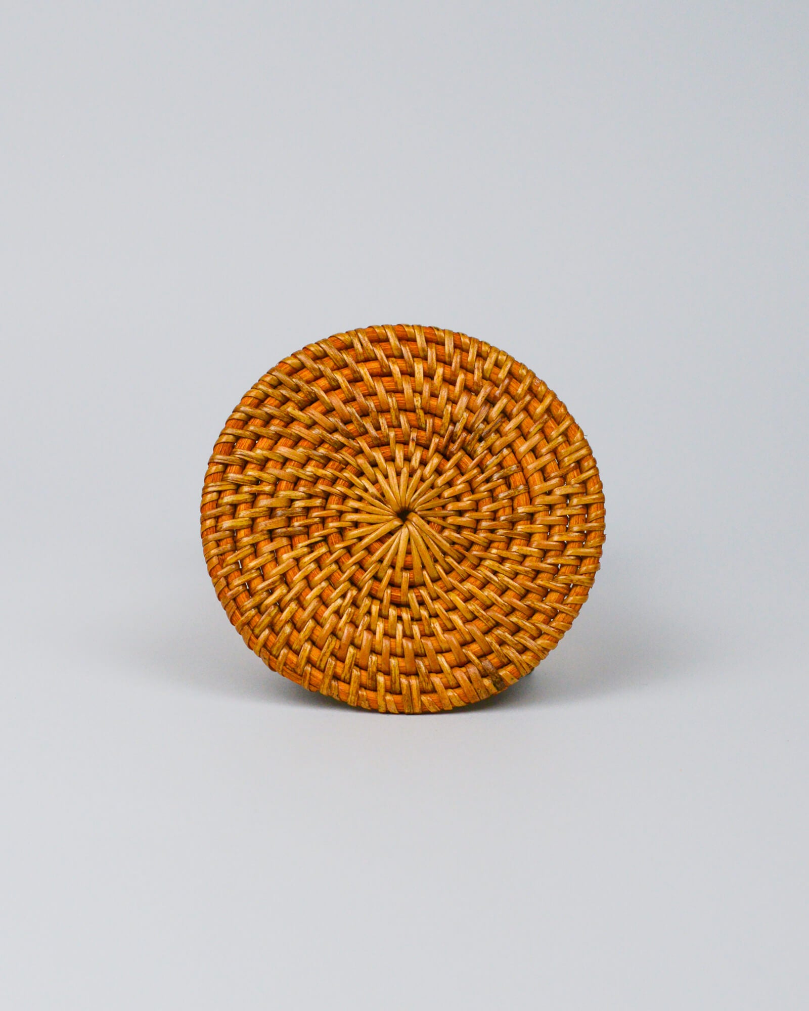 Round woven coaster on a white background