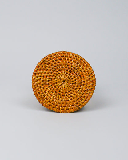 Round woven coaster on a white background