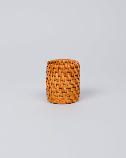 Rattan woven napkin ring on a white background
