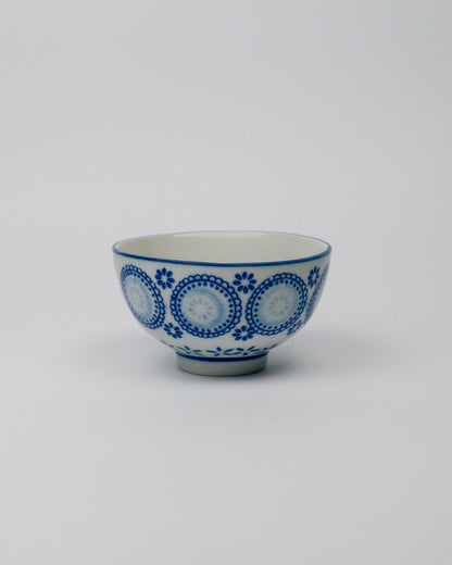 Ceramic bowl with blue circular patterns on a white background
