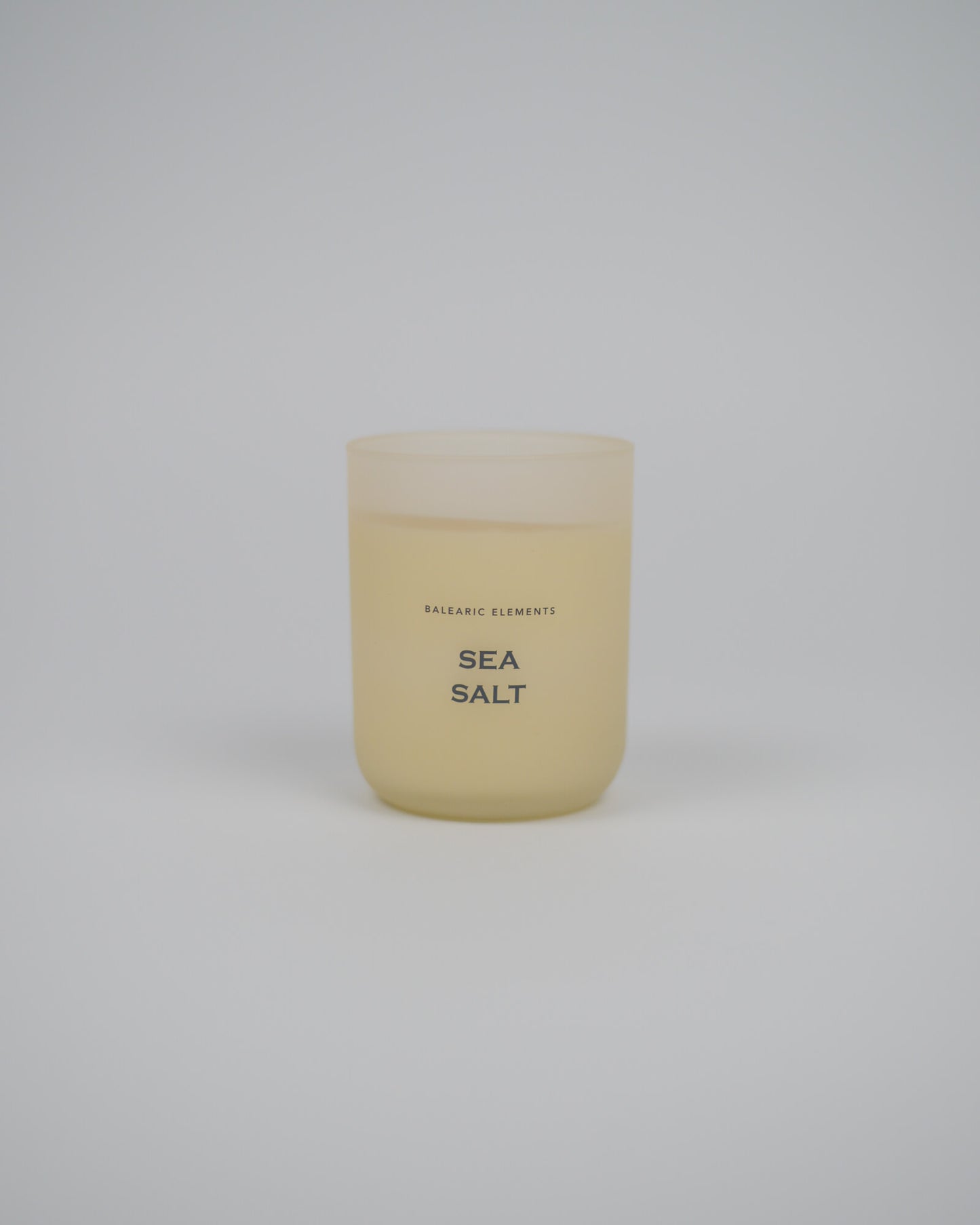 Scented candle labeled 'Sea Salt' on a white background