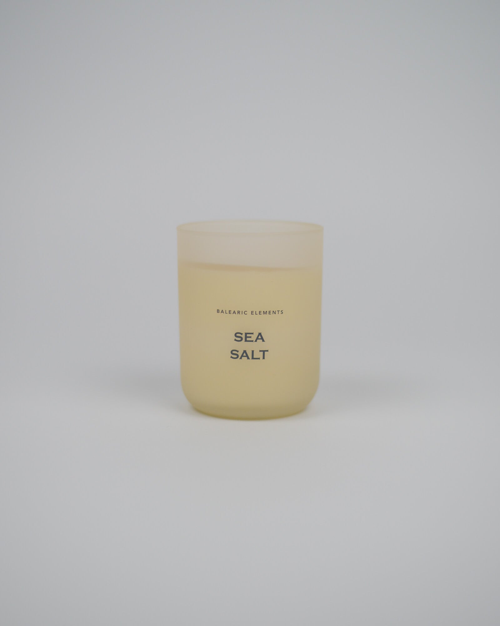 Scented candle labeled 'Sea Salt' on a white background