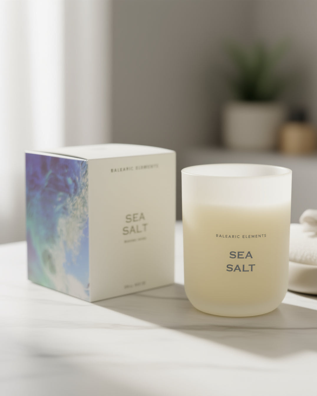 Sea Salt scented candle and packaging on a neutral background