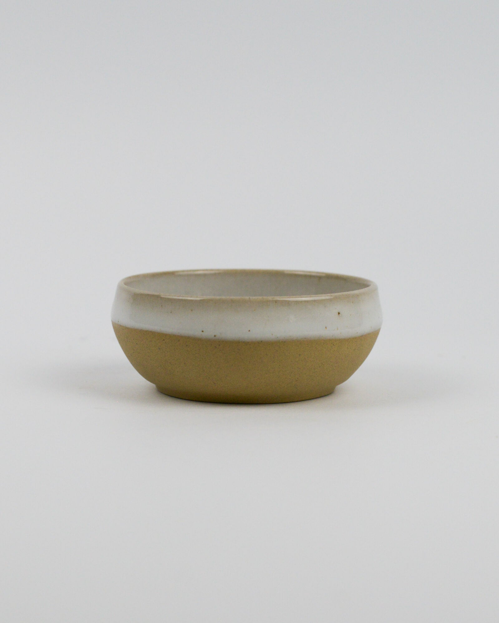 Ceramic stoneware bowl with two-tone design on a white background