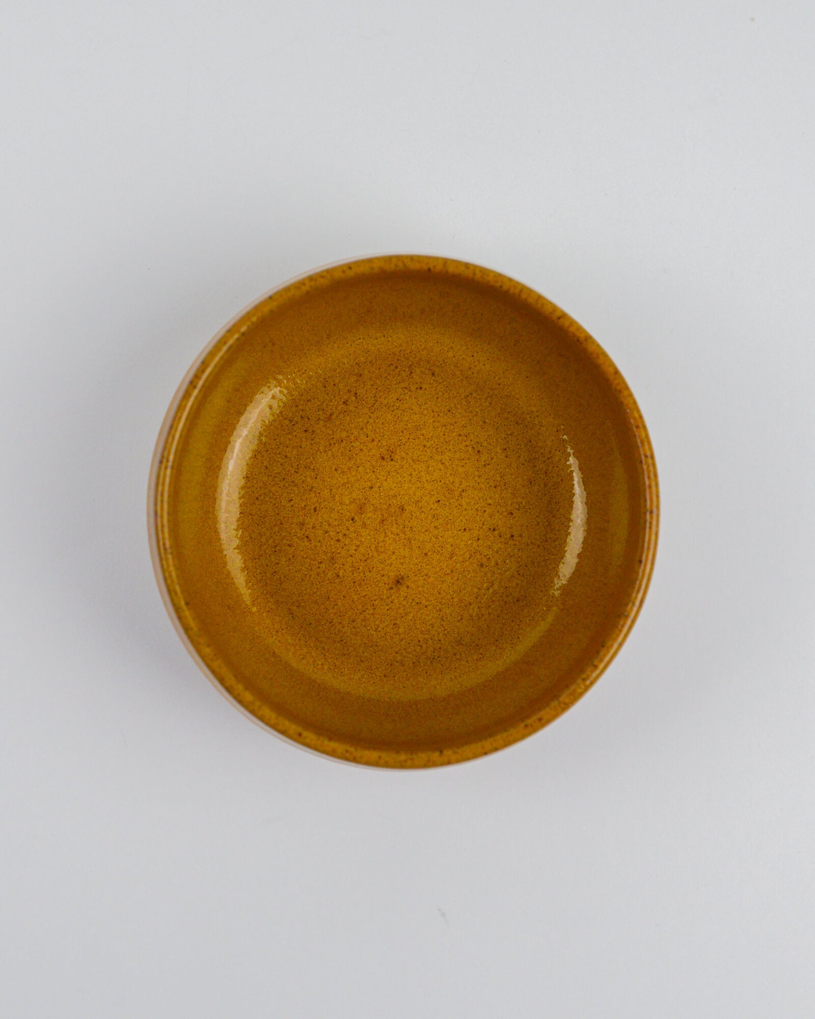 Yellow ceramic bowl on a white background