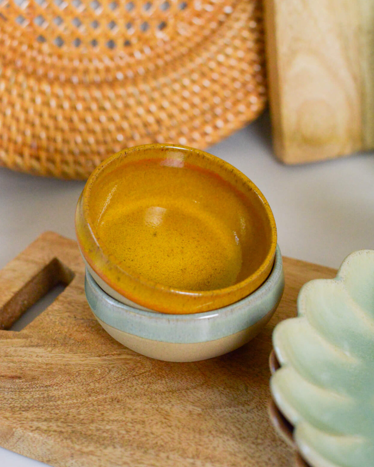 Ceramic dipping bowl with a gradient finish on a wooden surface