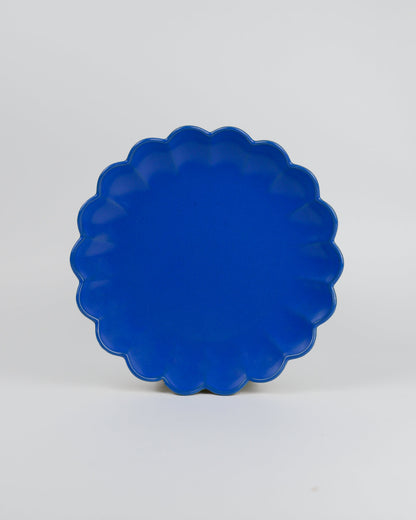Blue scalloped-edge dish on a white background