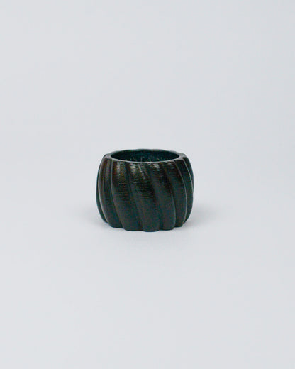 Dark wooden ribbed napkin ring on a white background