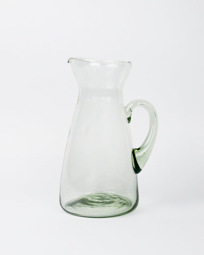 Clear glass pitcher on a white background