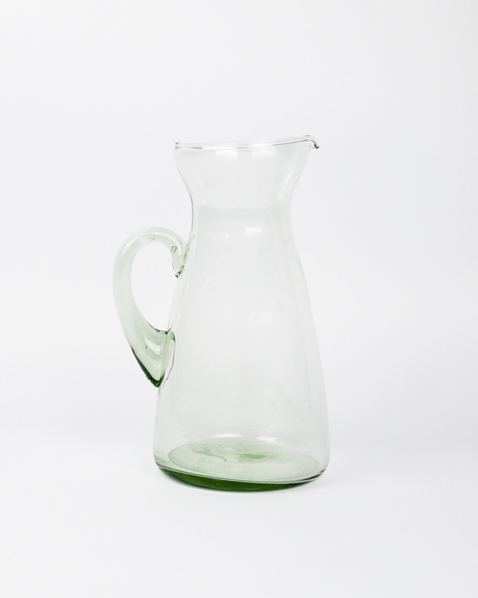 Clear glass pitcher on a white background