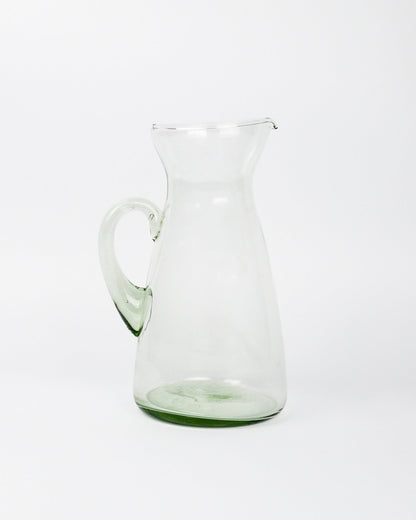 Clear glass pitcher on a white background