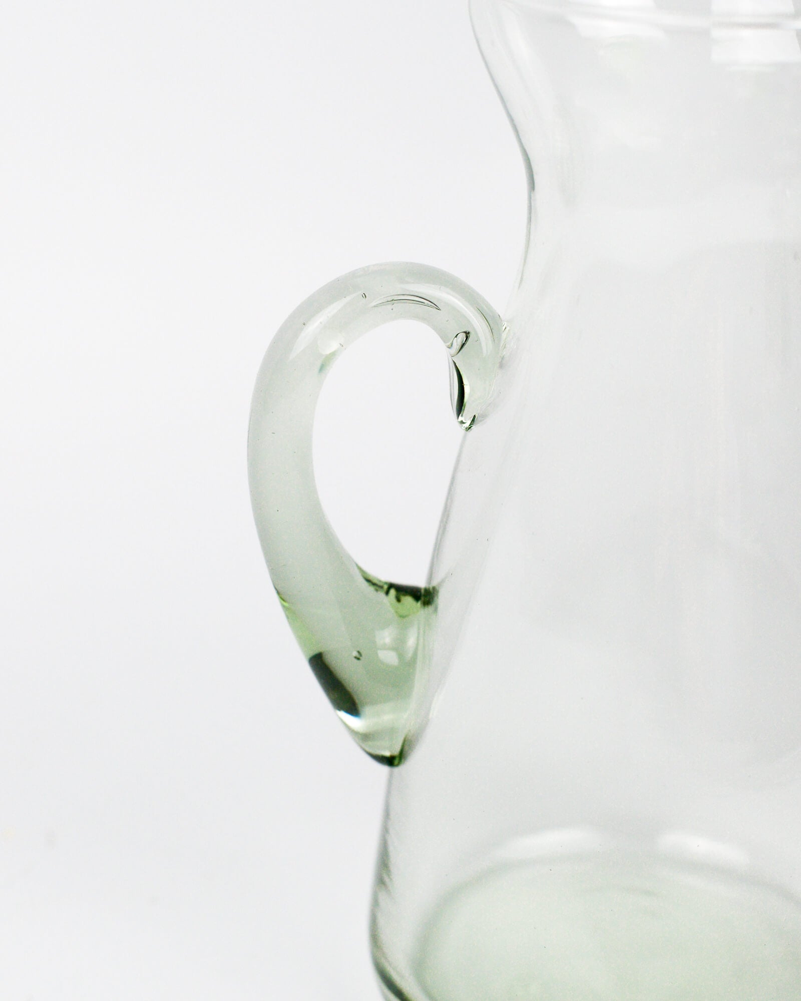 Clear glass pitcher on a white background