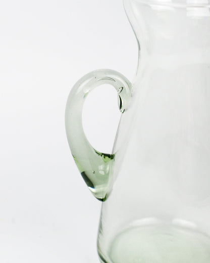 Clear glass pitcher on a white background
