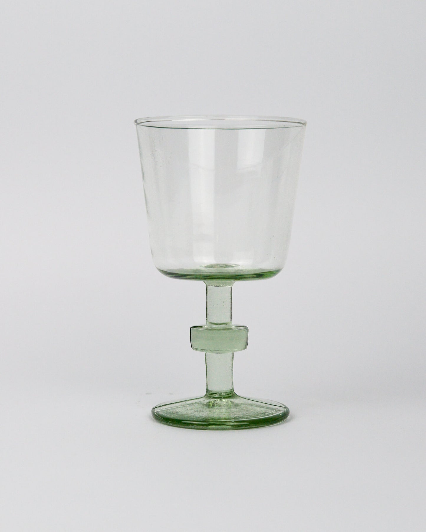 Clear recycled glass goblet wineglass on a white background