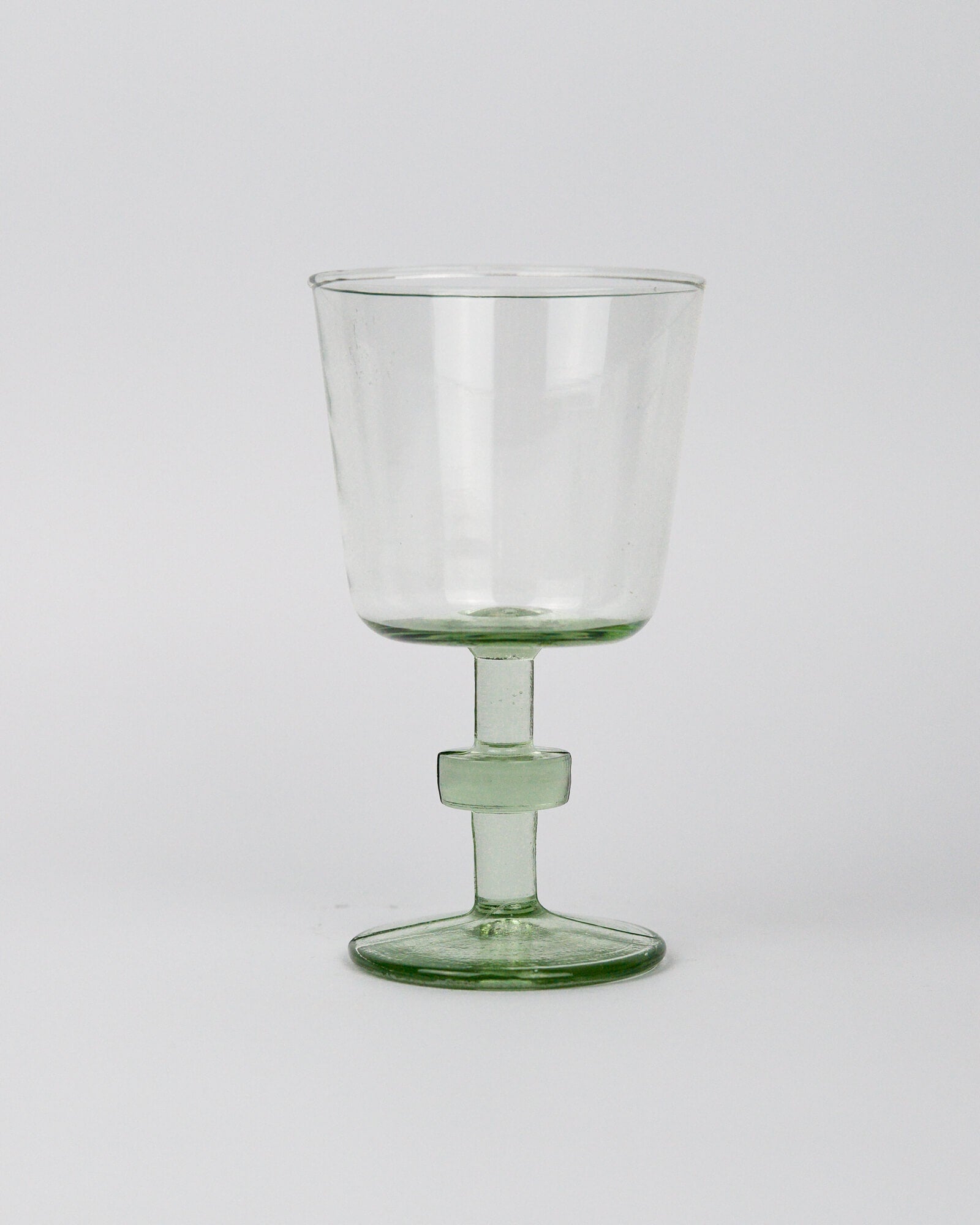 Clear recycled glass goblet wineglass on a white background