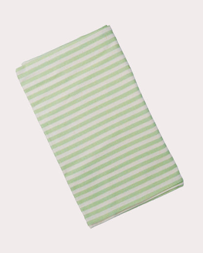 Cotton and linen blend table runner with green and white stripes on a white background
