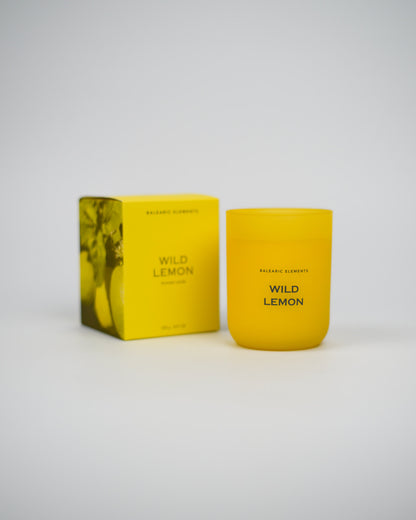 Yellow candle and packaging labeled 'Wild Lemon' on a white background