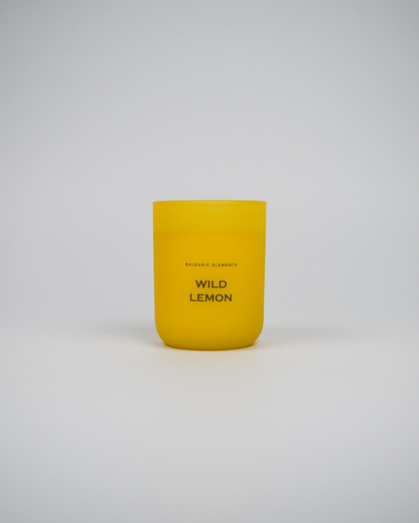 Yellow candle labeled 'Wild Lemon' on a white background