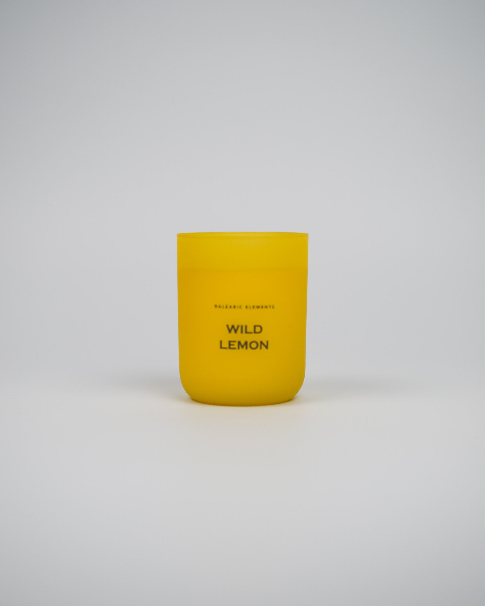 Yellow candle labeled 'Wild Lemon' on a white background