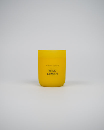 Yellow candle labeled 'Wild Lemon' on a white background